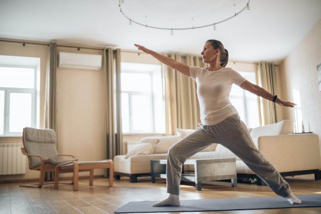 starting your day right: Woman practicing yoga at home