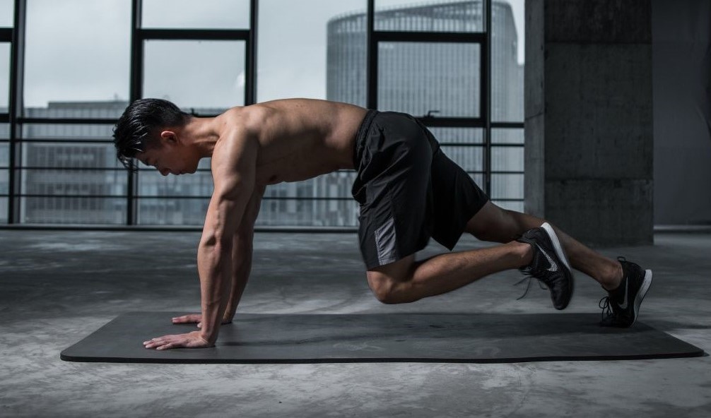 Men doing mountain climbers at home during a tabata workout for beginners