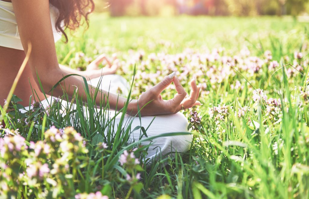 Origin of yoga: women meditating around nature