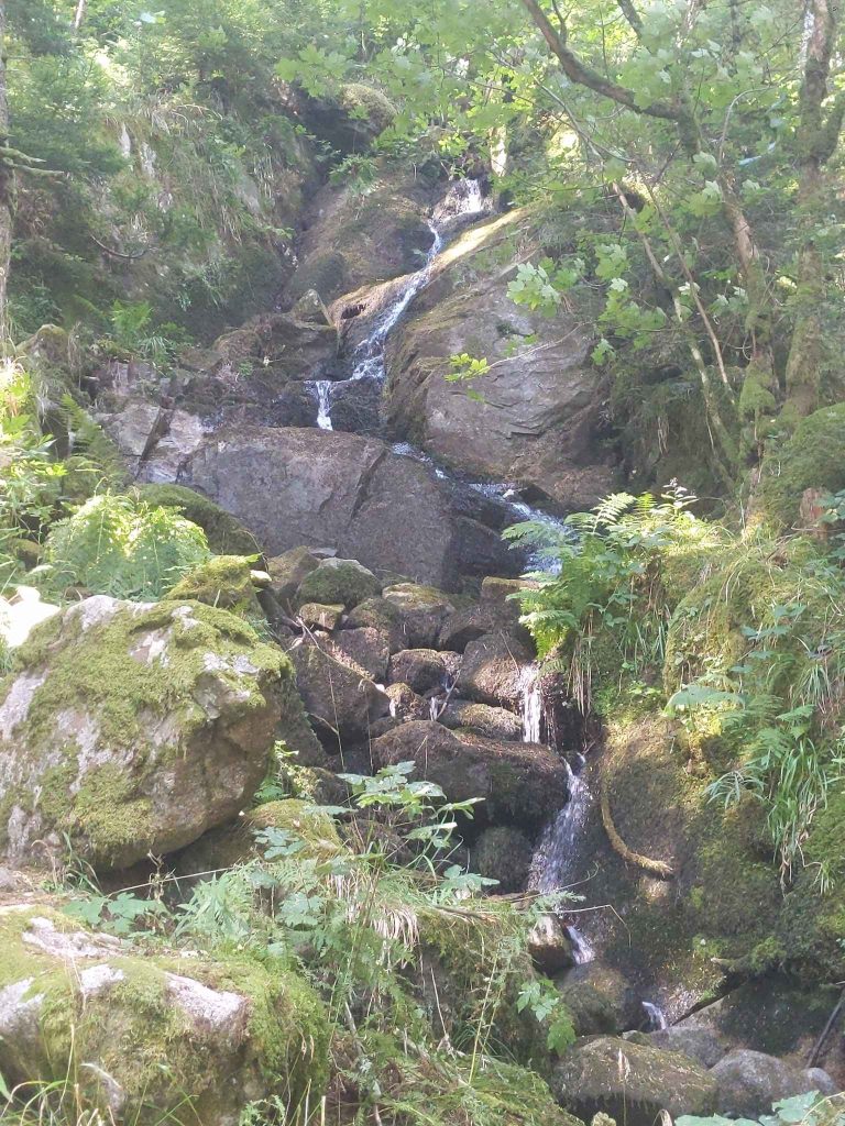 Hiking in france and its stunning waterfalls with big rocks