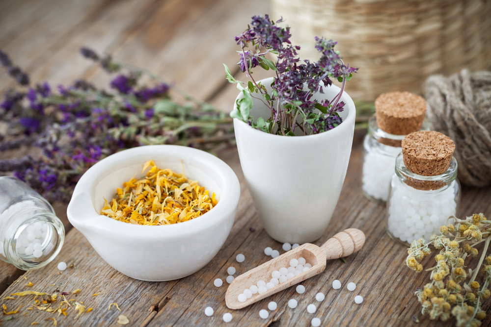 Mortar and,Bowl, of dried herbs and flowers with homeopathy as natural sleep aids