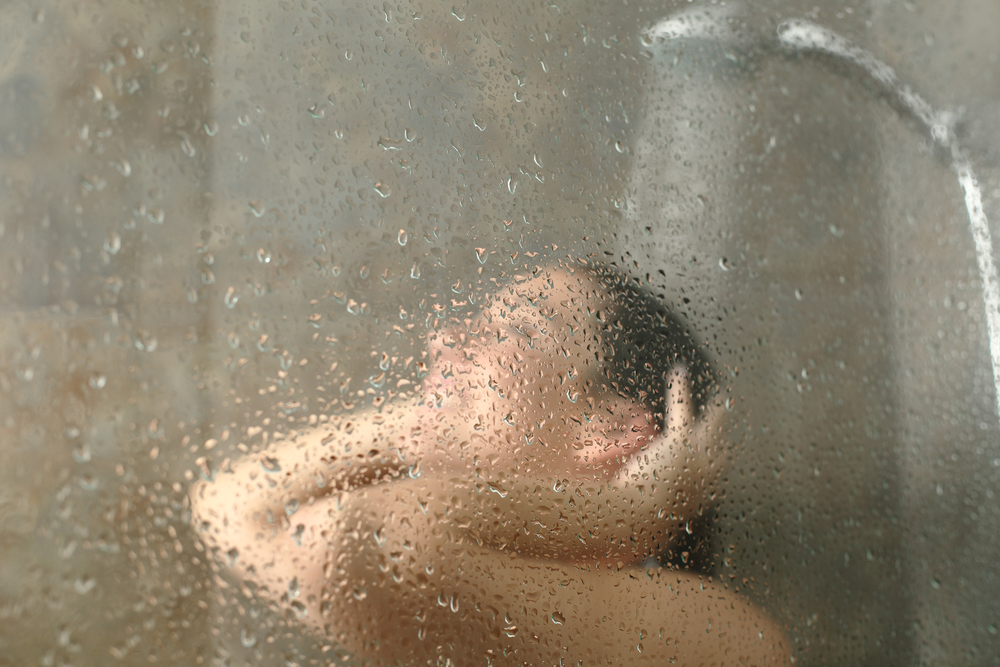 women taking a hot shower, temperature is one of the factors affecting sleep.