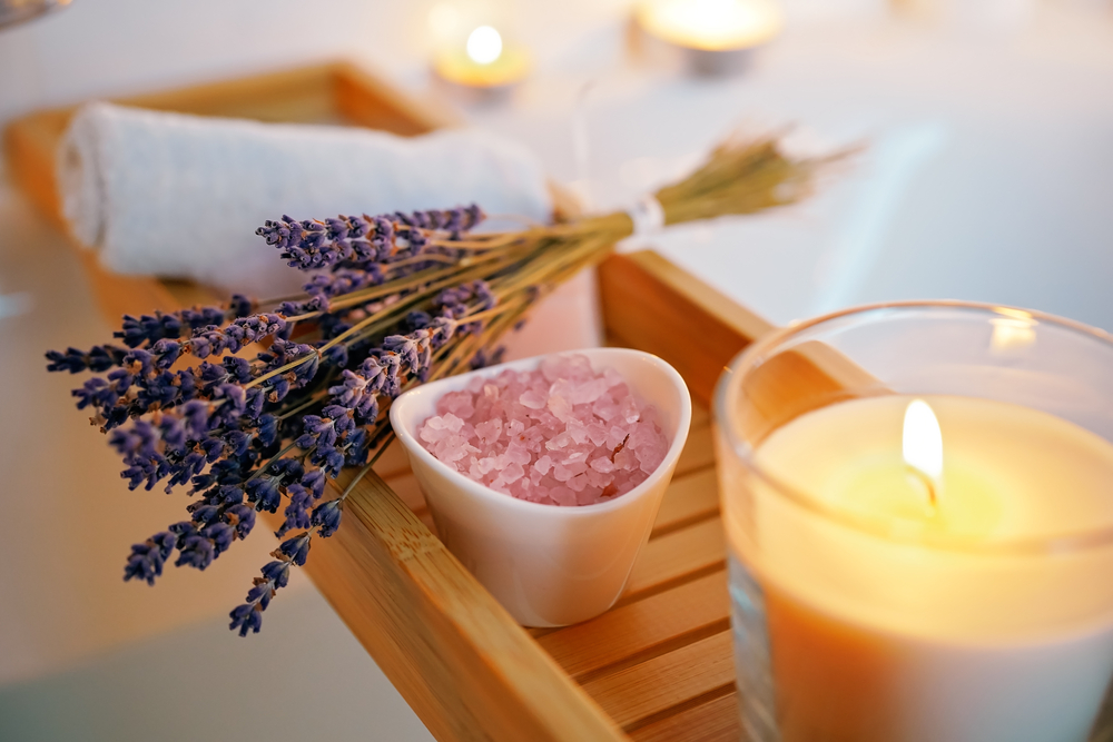 Cleansing ritual preparation for bath with candles and lavender, skin detoxification with hydrology