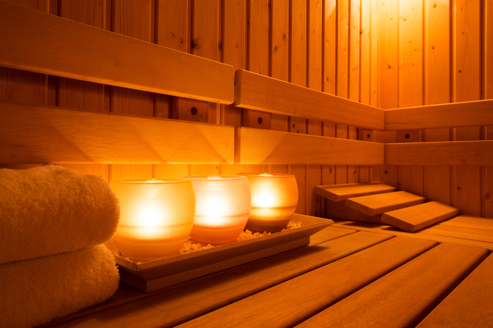 Nice wooden sauna with candle and towel, the perfect skin detoxification method