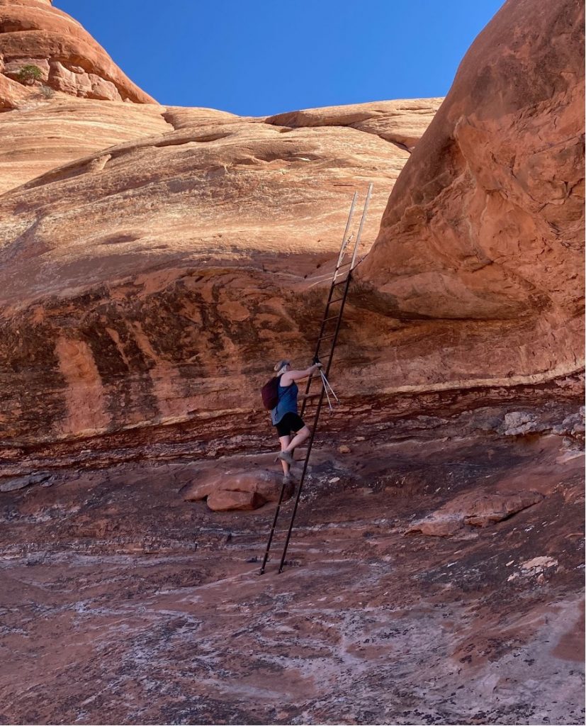 Utah national parks: Elephant and Big Spring Canyon - hiker climbing tall ladder