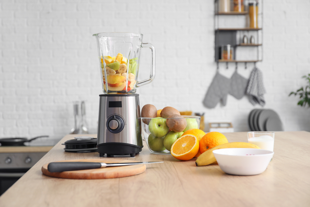 Modern,Blender useful to cook plant based diet,With,Fresh,Fruits,And,Cutting,Board,On,Table