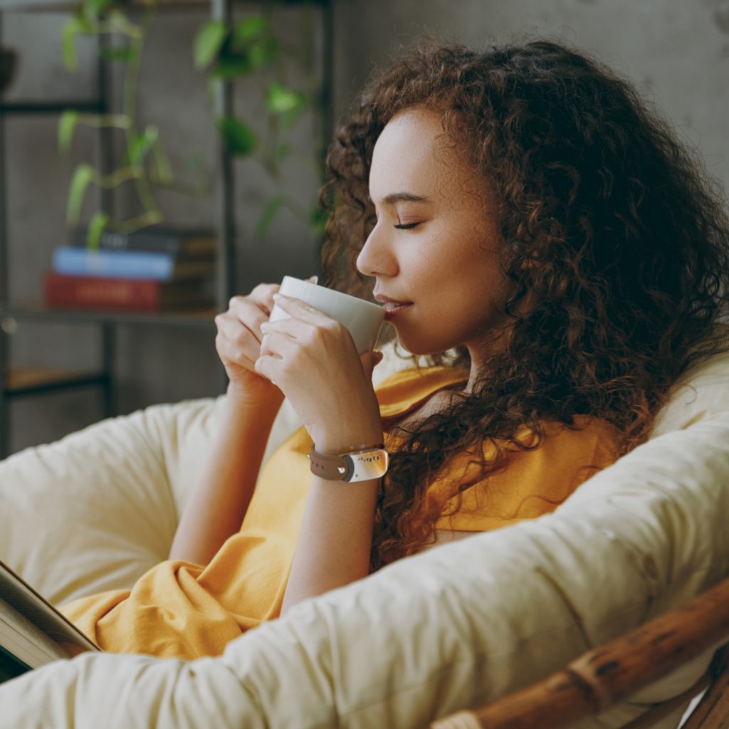 Peaceful woman drinking a hot beverage