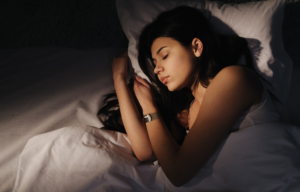 Women wearing a gema fitness tracker, sleeping and having rest.