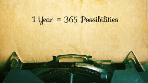 A sentence written on a typewritter "1 year = 365 possibilities"