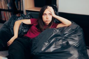 a person surrounded by trash bags