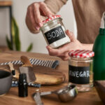 Unrecognizable person making cleaning product from ecological ingredients